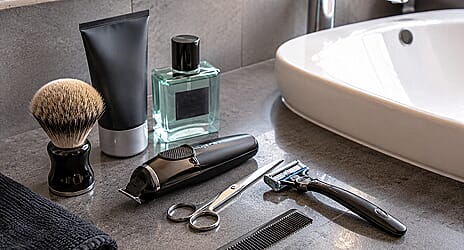 Multiple separate grooming tools cluttering a bathroom cabinet