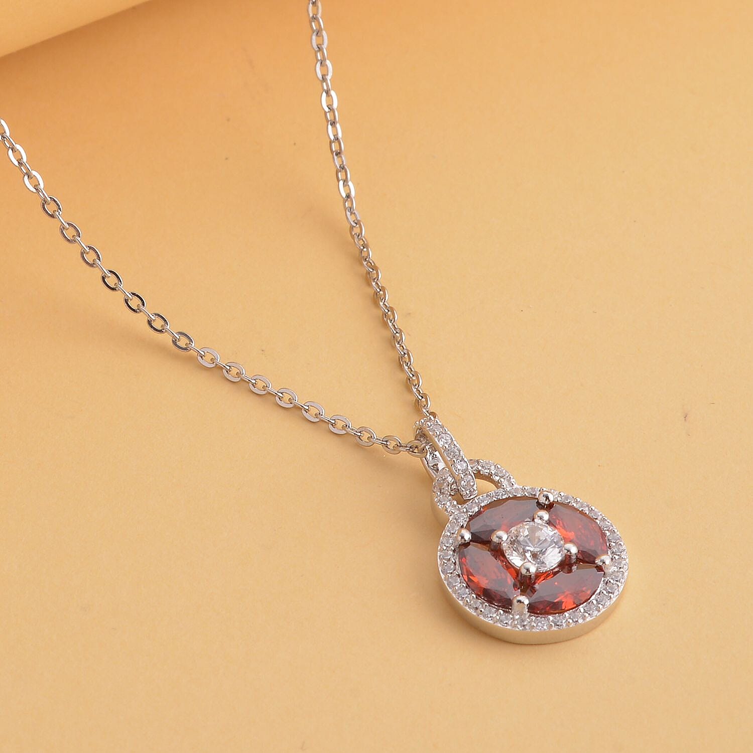Simulated Diamond and Simulated Garnet Circle of Life Pendant with Chain in Rhodium Overlay Sterling Silver