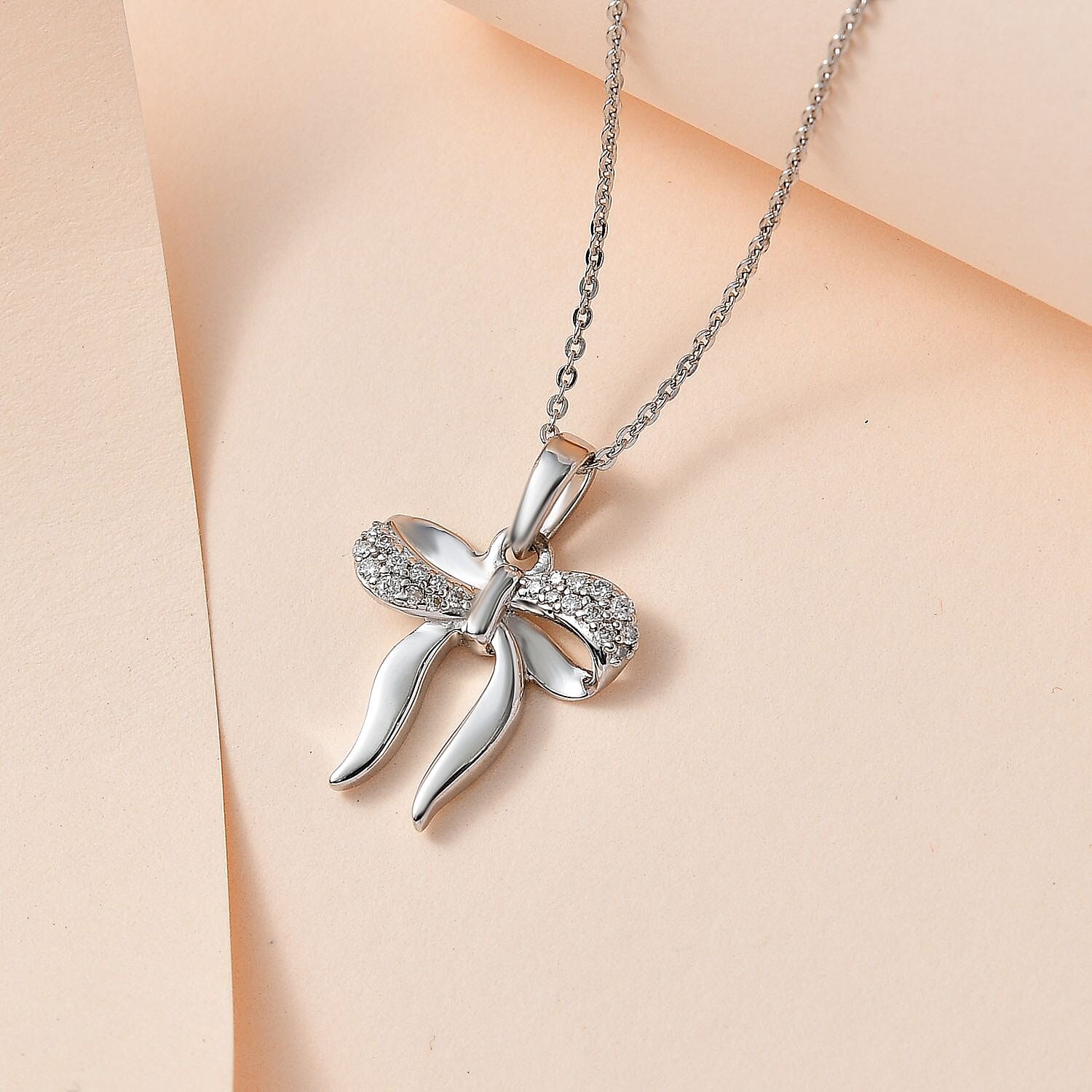 Moissanite Bow Tie Ribbon Pendant in Platinum Overlay Sterling Silver