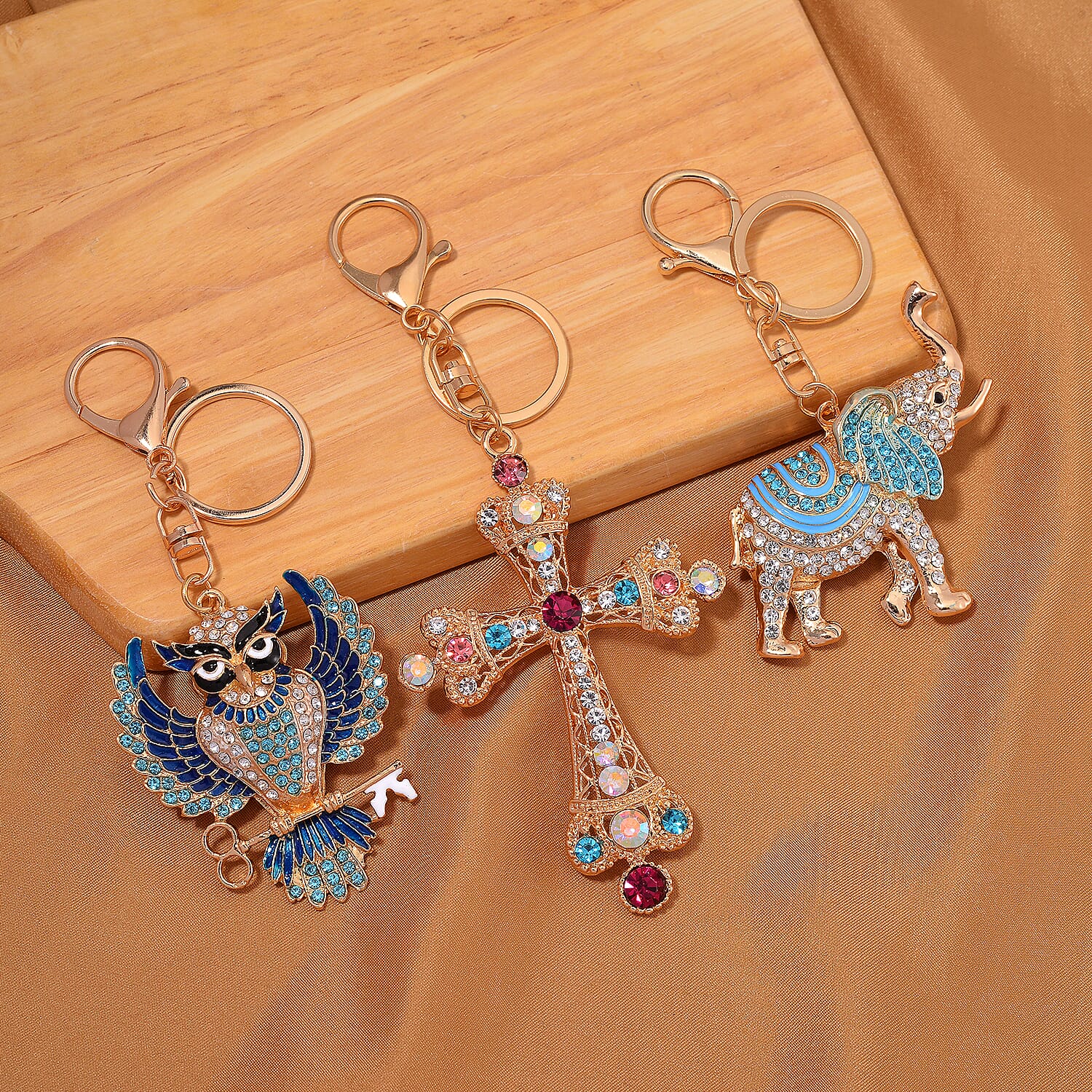 Set of 3 Crystal Key Chain in Yellow Gold Colour Plating. 1.Owl with Blue & White Crystal & Enamel; 2.Cross with Multi Color Crystal; 3.Elephant with Multi Color Crystal & Enamel.