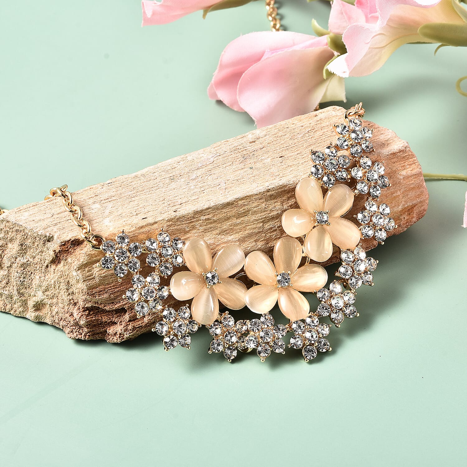 Simulated White Cats Eye, White Crystal Floral Cluster Necklace (Size 20) in Gold Tone