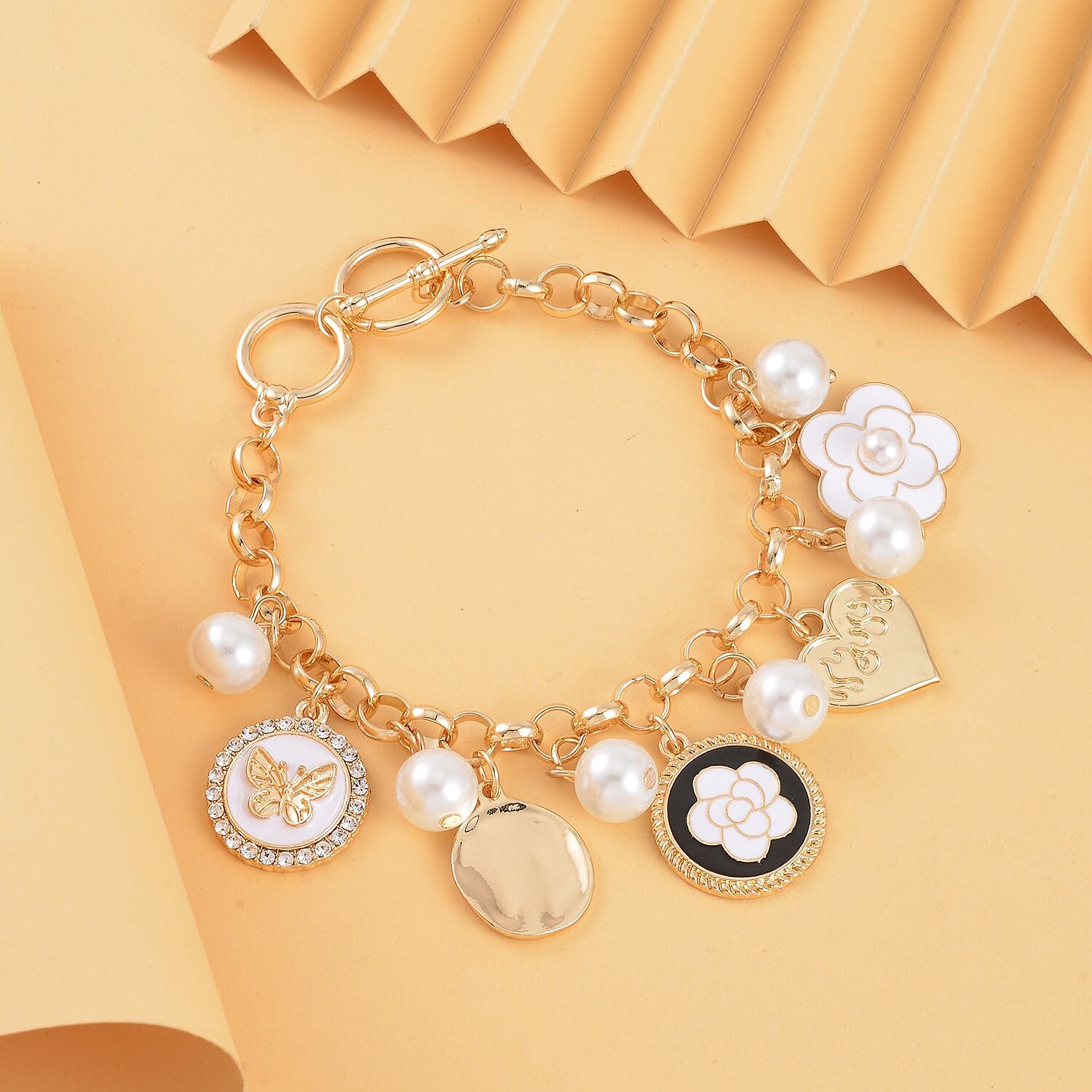 White Shell Pearl and White Austrian Crystal Enamelled Charms Bracelet (Size - 7.5) in Yellow Gold Tone