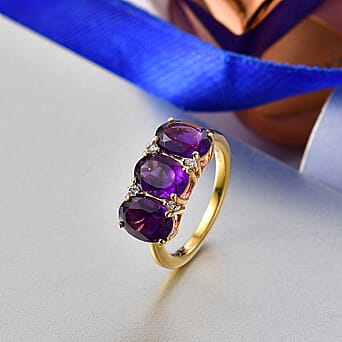 https://tjcuk.sirv.com/Products/84/6/8466381/D-Joy-African-Amethyst-White-Zircon-3-Stone-Ring-in-Yellow-Gold-Plated_8466381_2.jpg?w=342&h=342