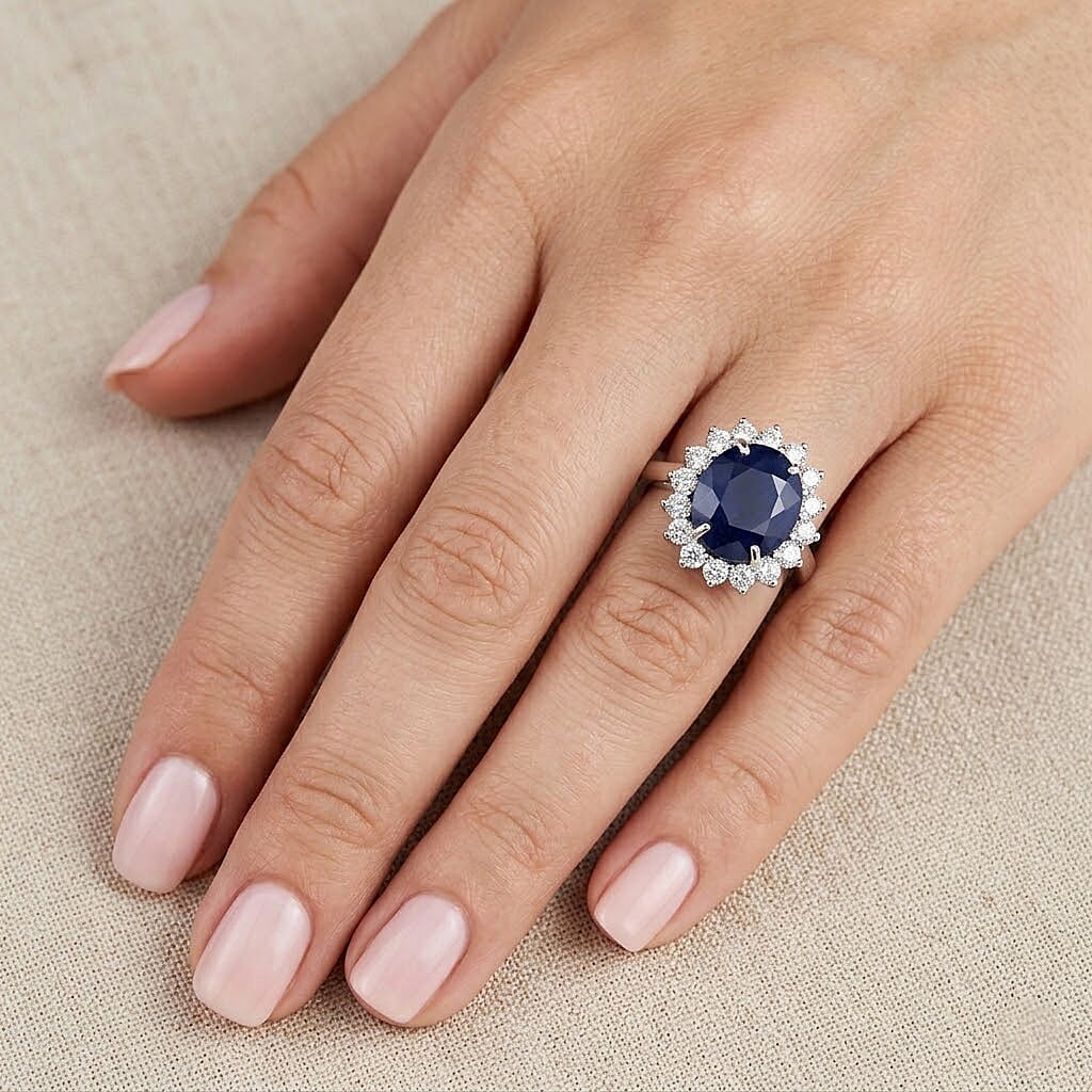 Blue Sapphire (Oval 12x10 mm, 7.10Cts) & Lab Grown Diamond (SI-G-H, 1.00Cts) Halo Ring in Rhodium Overlay Sterling Silver 8.10 Ct.